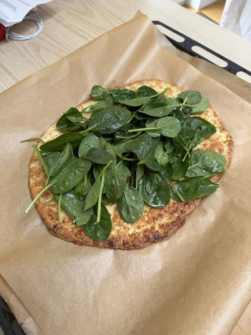 Fresh spinach goes on the base